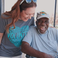 Rufus sharing a good laugh with his Meals on Wheels volunteer
